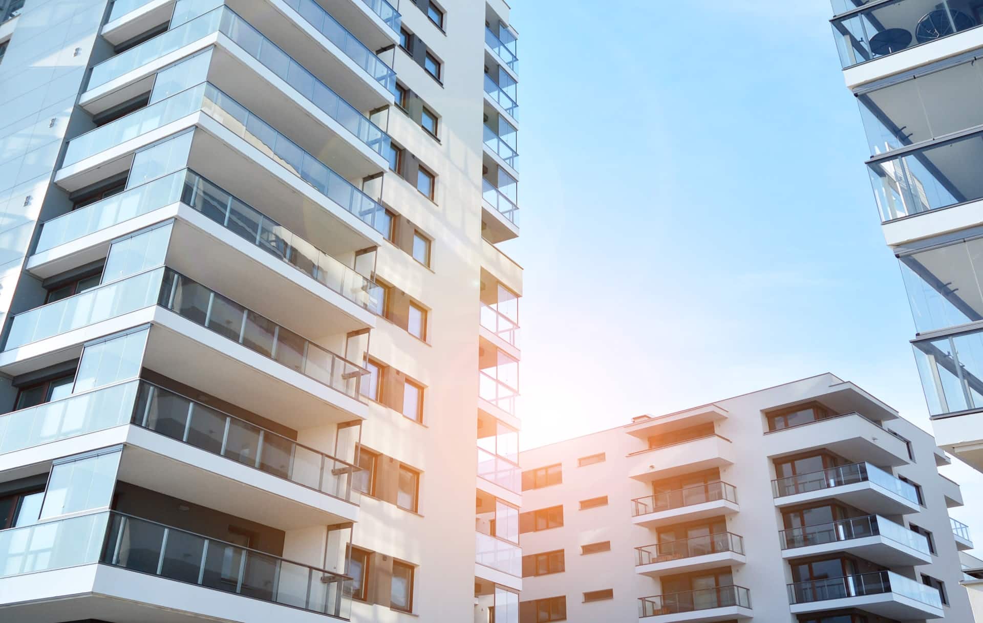 view up at three apartment buildings